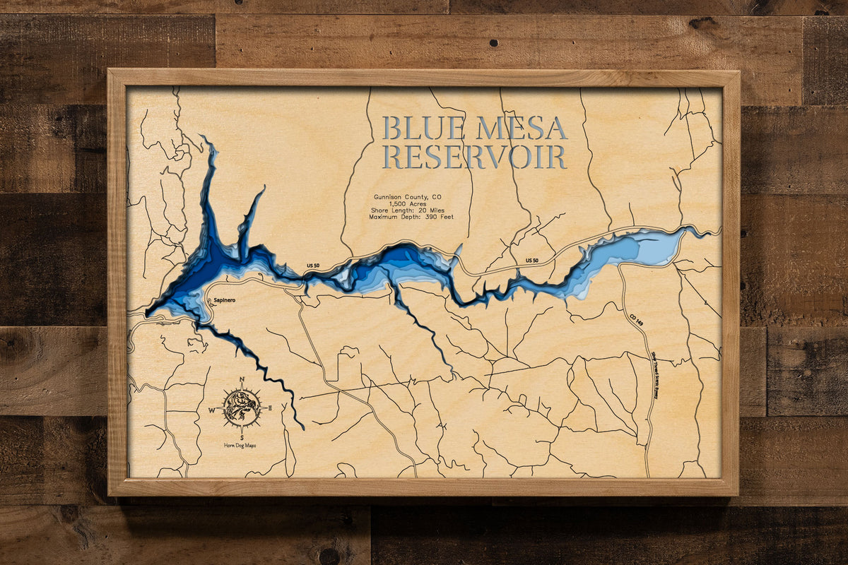 A laser-cut, layered wood map of Blue Mesa Reservoir, Colorado, showcasing its expansive shoreline and surrounding mountainous terrain.