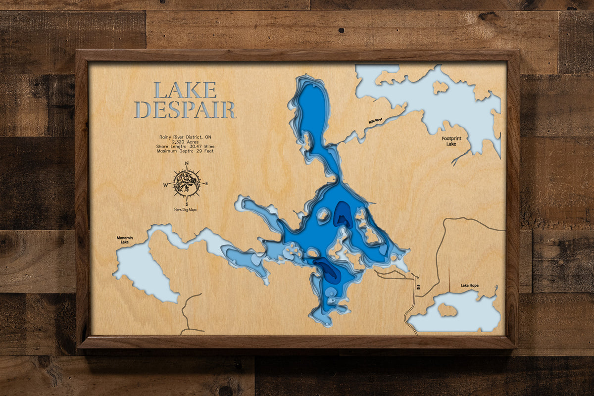A beautifully detailed, laser-cut, multi-layered wooden map of Lake Despair in Rainy River District, Ontario, showcasing the lake's shallow contours and tea-colored waters, the intricate shoreline dotted with islands, and the connecting waterways of Mile River leading to Footprint Lake and Jackfish Narrows.