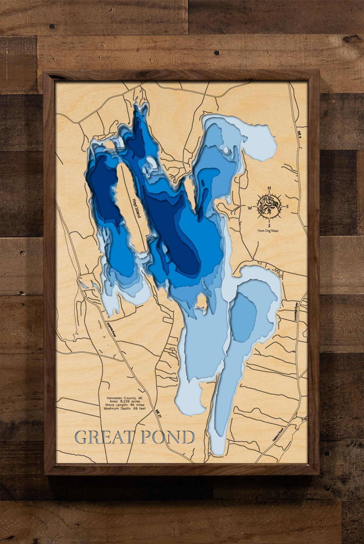 A laser-cut, layered wood map of Great Pond, Maine, showing its irregular shoreline and surrounding forested landscapes in Kennebec County.