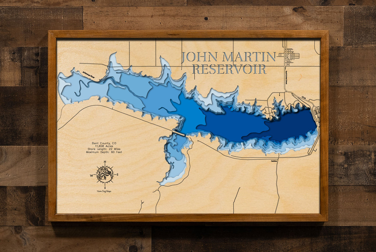 A laser-cut, layered wood map of John Martin Reservoir, Colorado, showcasing its vast shoreline and surrounding prairie landscape.