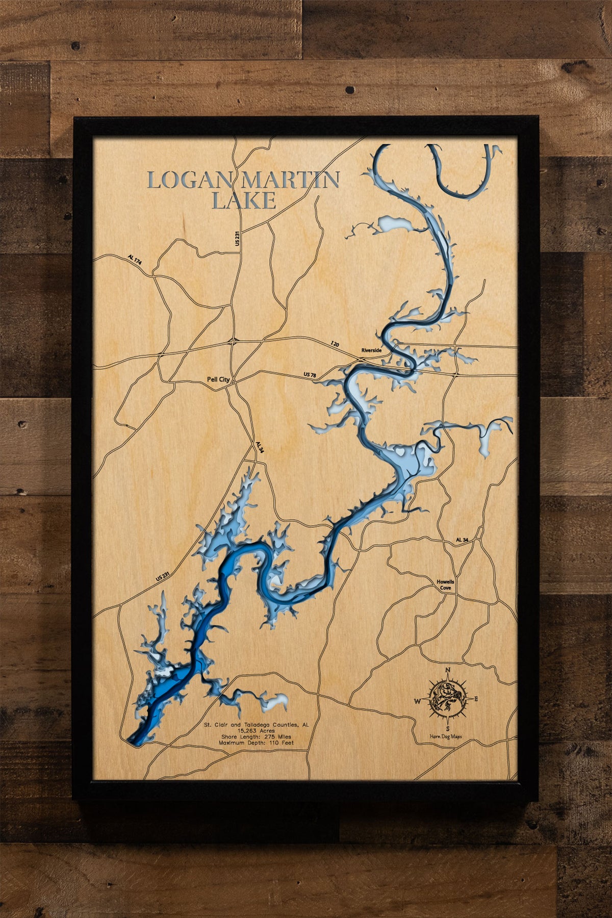 A precision laser-cut, multi-layered wooden map of Logan Martin Lake in St. Clair and Talladega Counties, Alabama — a 15,263-acre Coosa River reservoir nicknamed the "Lake of a Thousand Coves" with 275 miles of shoreline. The natural wood top layer captures every dramatic cove in fine detail, while a light-to-dark blue gradient conveys the lake's 110-foot depth. A handcrafted statement piece for any Alabama lake home, cabin, or outdoor enthusiast's wall.