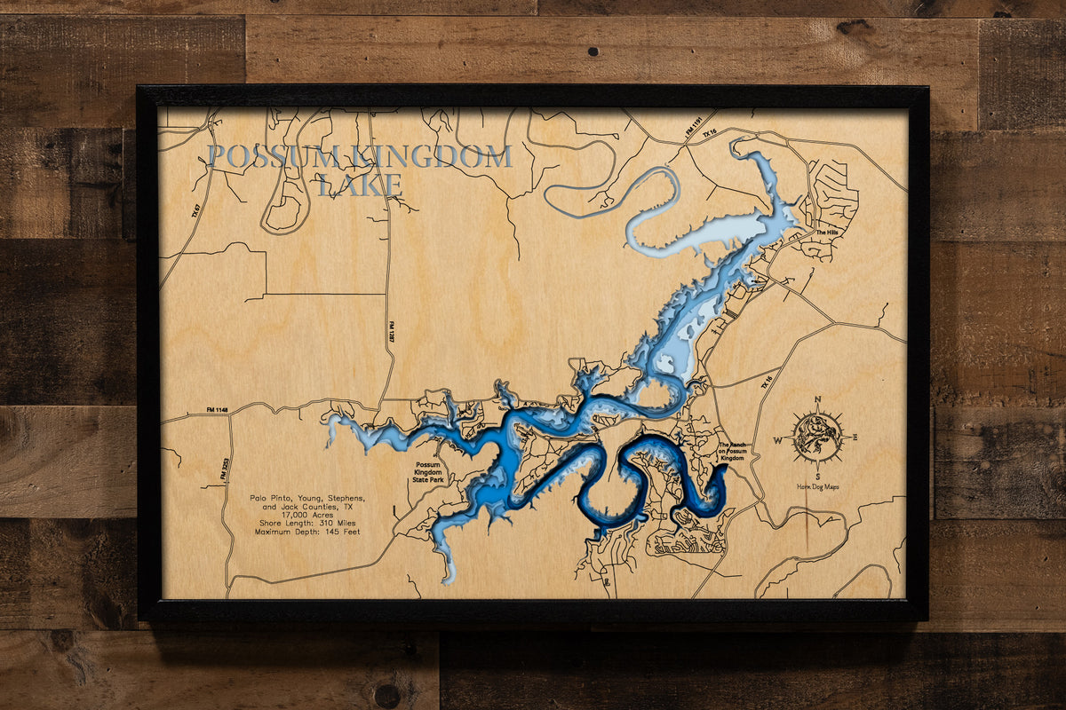 An exquisitely detailed, multi-layered laser-cut wooden topographic map of Possum Kingdom Lake winding through the Palo Pinto Mountains across four Texas counties, featuring depth contours illustrating the dramatic 145-foot maximum depth, the serpentine 310-mile shoreline carved through limestone canyons, the iconic Hell's Gate formation with its towering cliffs, Morris Sheppard Dam at the southern terminus, and the 65-mile stretch of pristine blue water following the ancient Brazos River channel.
