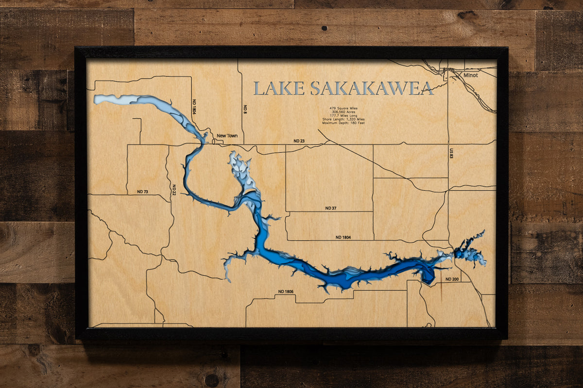 A highly detailed, laser-cut, and multi-layered wooden map of Lake Sakakawea stretching across six North Dakota counties. The map showcases the reservoir's impressive 178-mile length along the Missouri River, with depth contours highlighting the 180-foot maximum depth, the expansive Van Hook Arm, and the 1,320 miles of intricate shoreline detail.
