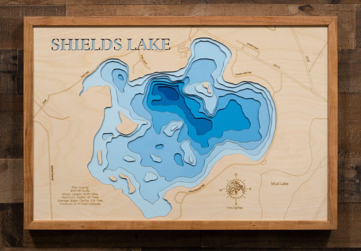 Laser-engraved relief map of Shields Lake in Rice County, MN, crafted from wood with high precision.