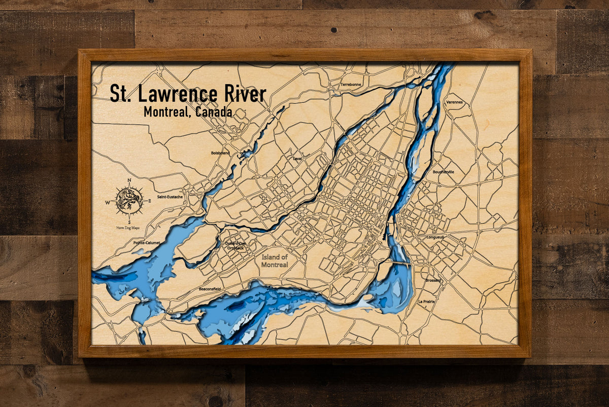 An aerial view capturing the wide expanse of the St. Lawrence River as it flows past the verdant Island of Montreal. The city's skyline, bridges, and the natural contours of the island are visible against the backdrop of the powerful waterway. The image emphasizes the river's scale and its significant geographical and urban presence.