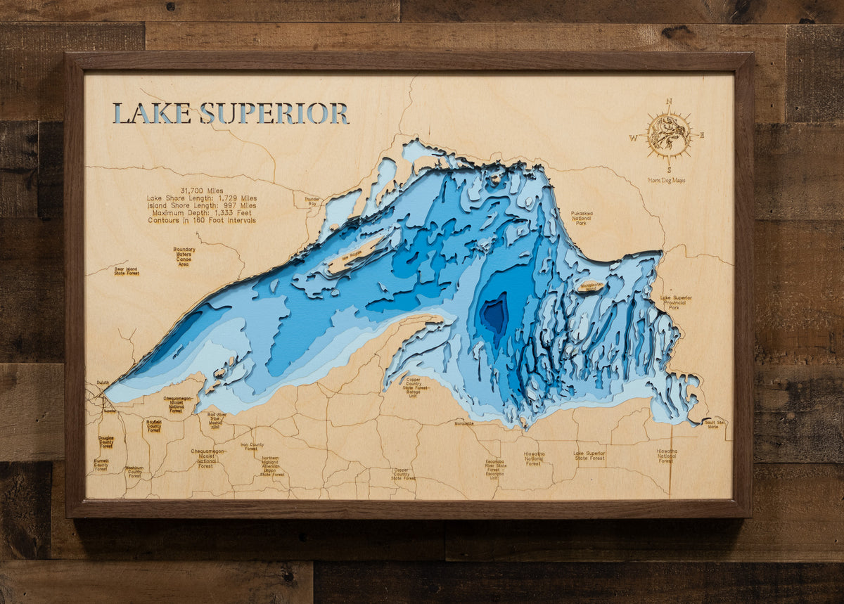 3D Lake superior map in a walnut frame on a cabin wall, showcasing detailed depth layers and shoreline features.
