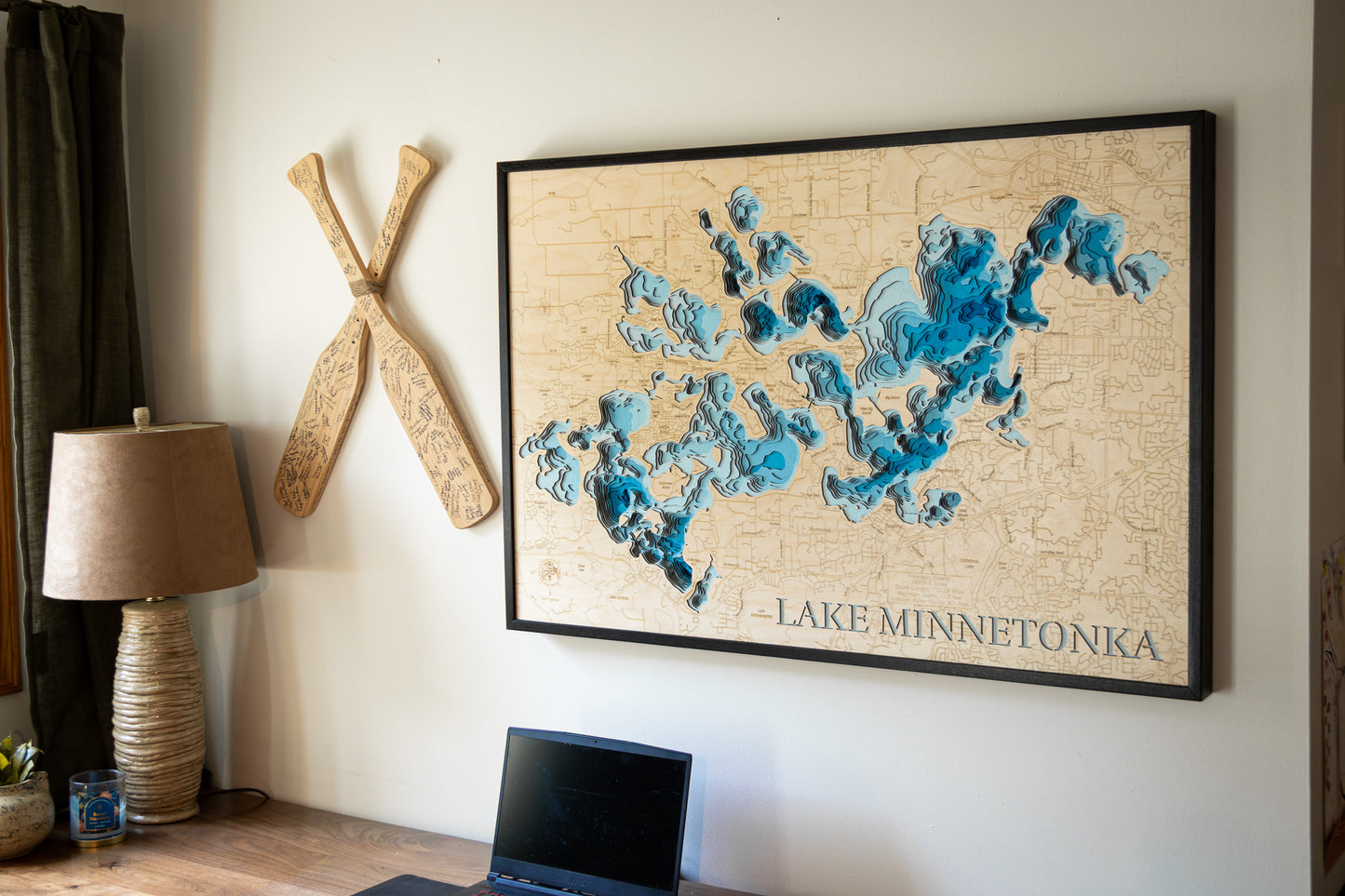 3D Lake Minnetonka map in a sleek black frame, displayed in a modern setting with contemporary decor elements.