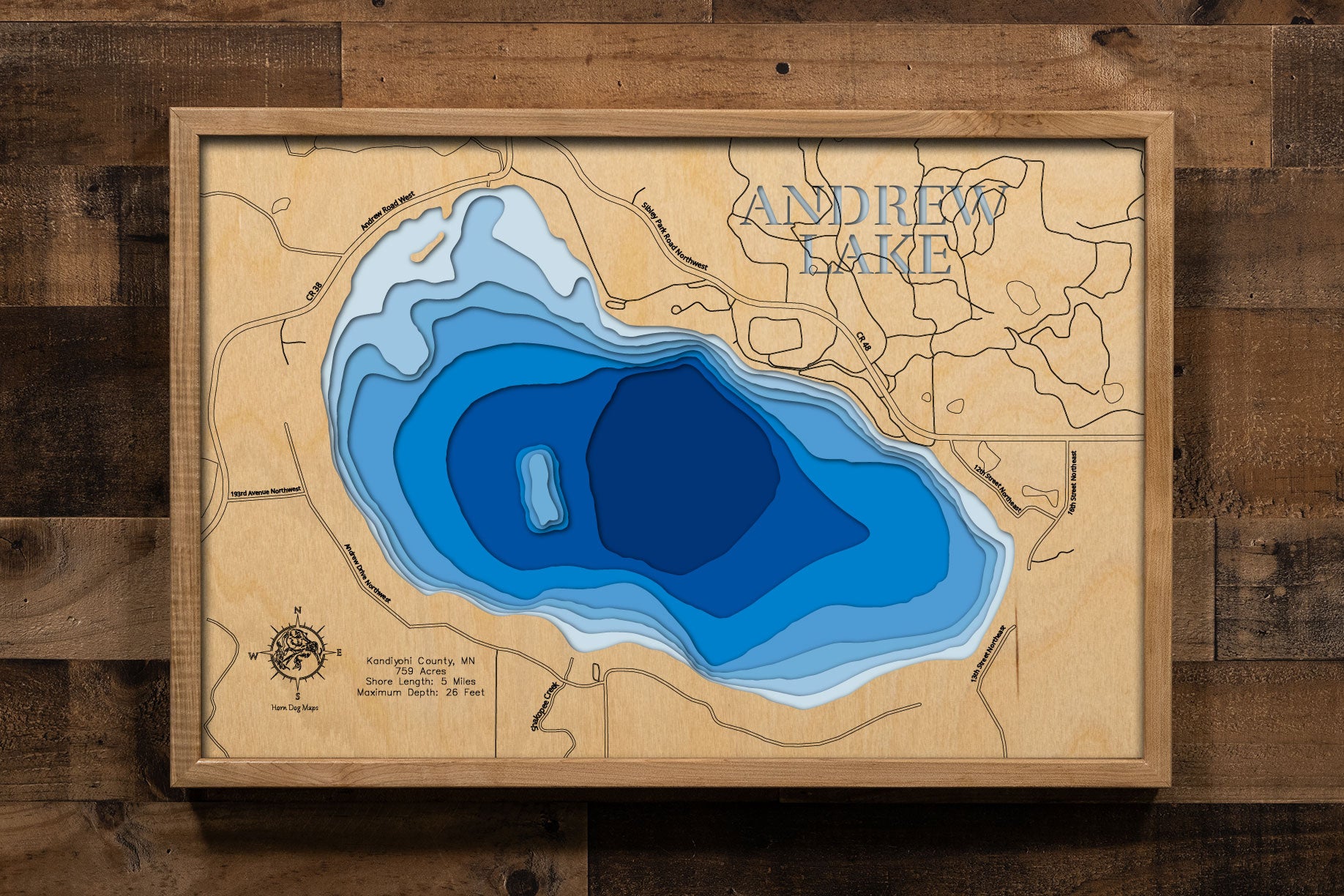 A precision laser-cut, multi-layered wooden map of Andrew Lake in Kandiyohi County, Minnesota — a 759-acre lake named for a pioneer settler in the heart of the Willmar Lakes Area. The natural wood top layer captures 5 miles of shoreline in fine detail, while a light-to-dark blue gradient conveys the lake's 26-foot depth. A handcrafted statement piece for any Minnesota lake home, cabin, or outdoor enthusiast's wall.