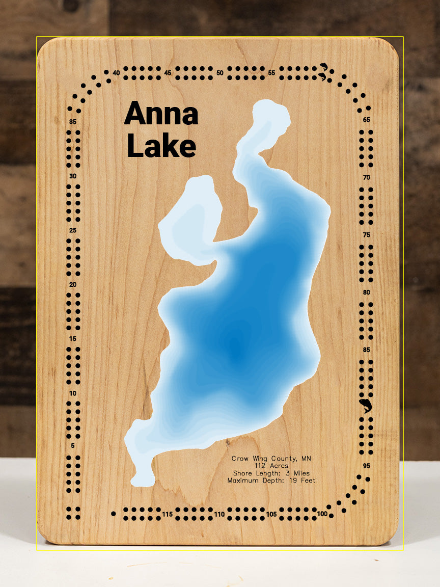 A precision laser-cut, multi-layered wooden map of Anna Lake in Crow Wing County, Minnesota. The natural wood top layer captures 3 miles of intimate shoreline in fine detail, while a light-to-dark blue gradient conveys the lake's shallow, peaceful character. A handcrafted wall art piece and meaningful gift for any Minnesota lake cabin or Brainerd Lakes retreat.