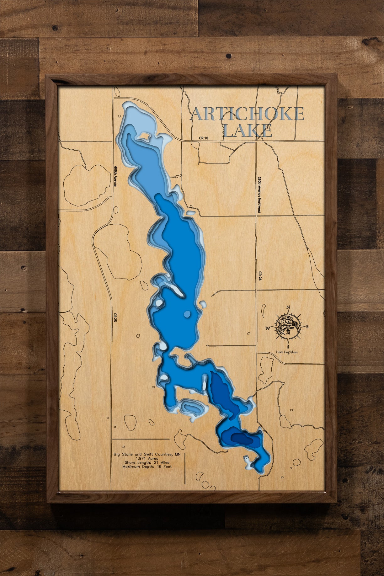 A highly detailed, laser-cut, and multi-layered wooden map of Artichoke Lake spanning Big Stone and Swift Counties in western Minnesota. The map illustrates the lake's 1,971-acre surface with its shallow 16-foot maximum depth, the distinctive narrows section with its winter aeration system, and the intricate 21 miles of shoreline featuring multiple reefs and points.
