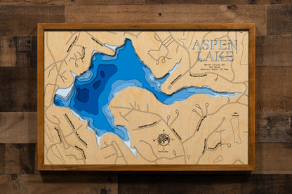 A precision laser-cut, multi-layered wooden map of Lake Aspen in Warren County, Missouri, the beloved centerpiece of Innsbrook Resort just 45 minutes west of St. Louis. The natural wood top layer captures the wooded, cove-lined shoreline of this 150-acre private lake in fine detail, while a light-to-dark blue gradient conveys its 25-foot depth. A handcrafted statement piece for any Innsbrook chalet, Missouri lake home, or outdoor enthusiast's wall.