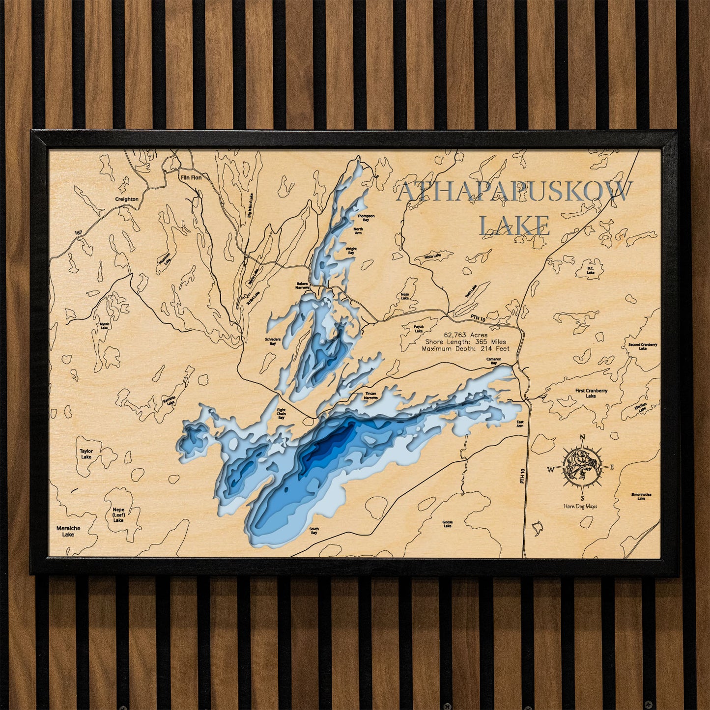 Artisanally carved wooden lake map of Athapapuskow Lake in Manitoba and Saskatchewan, highlighting bathymetry.