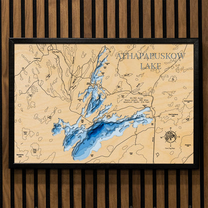 Artisanally carved wooden lake map of Athapapuskow Lake in Manitoba and Saskatchewan, highlighting bathymetry.