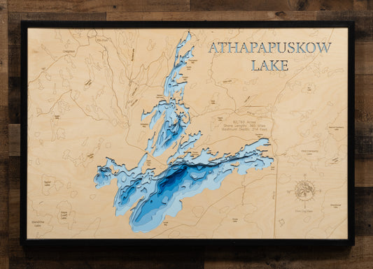 Artisanally carved wooden lake map of Athapapuskow Lake in Manitoba and Saskatchewan, highlighting bathymetry.