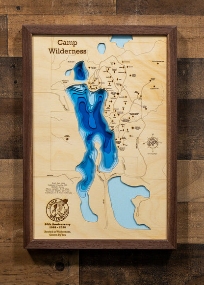 A precision laser-cut, multi-layered wooden map of Bad Axe Lake in Hubbard County, Minnesota — home to the legendary Camp Wilderness Scout Camp. The natural wood top layer traces the lake's pristine, protected shoreline in fine detail, while a light-to-dark blue gradient highlights the water's depth and dimension. A meaningful and rustic statement piece for a lodge, troop room, or Scout family home.