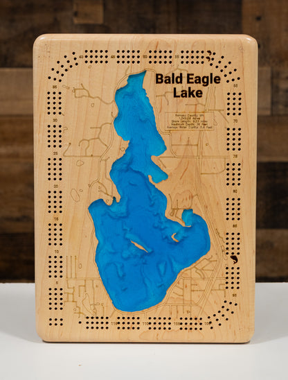 A square wooden tabletop game board featuring a blue resin map of Bald Eagle Lake, with engraved street details, numbered holes, and the text 'Bald Eagle Lake' on the front.