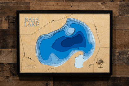A precision laser-cut, multi-layered wooden map of Bass Lake in Crow Wing County, Minnesota, located near Merrifield in the heart of the Brainerd Lakes region. The natural wood top layer captures 3 miles of shoreline in fine detail, while a light-to-dark blue gradient conveys the lake's 38-foot depth. A handcrafted statement piece for any Minnesota lake cabin, home, or outdoor enthusiast's wall.