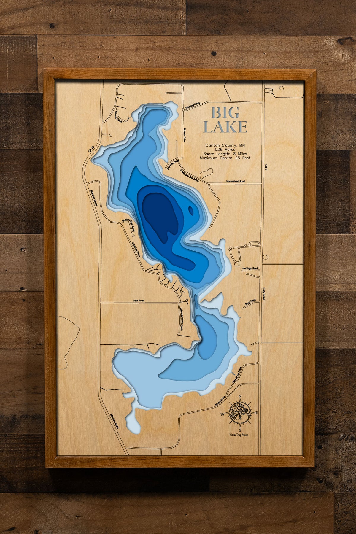 A precision laser-cut, multi-layered wooden map of Big Lake in Carlton County, Minnesota, a 526-acre lake near Sawyer with 8 miles of diverse shoreline and a thriving Largemouth Bass and Bluegill fishery. The natural wood top layer captures every curve of this expansive lake in fine detail, while a light-to-dark blue gradient conveys its broad, shallow character. A handcrafted statement piece for any Minnesota lake home, cabin, or outdoor enthusiast's wall.