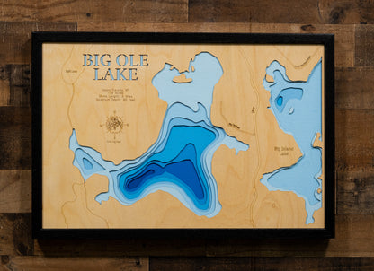 A precision laser-cut, multi-layered wooden map of Big Ole Lake in Itasca County, Minnesota, located near Marcell in the heart of the Northwoods. The natural wood top layer captures 5 miles of forested shoreline in fine detail, while a light-to-dark blue gradient conveys the lake's 65-foot depth. A handcrafted statement piece for any Minnesota cabin, lake home, or outdoor enthusiast's wall.