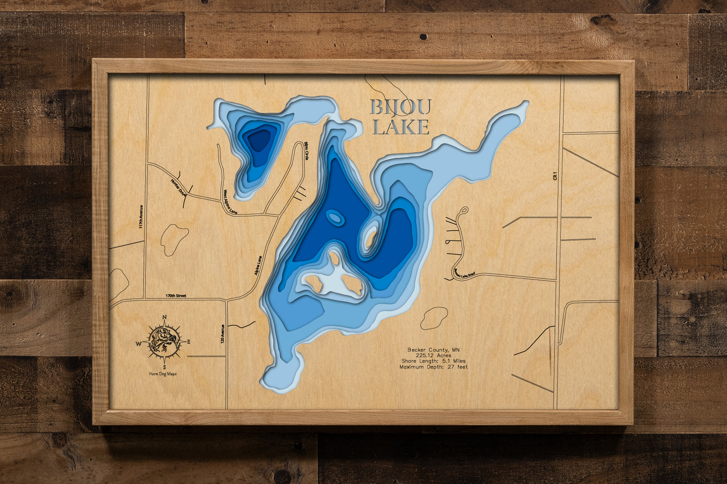 A custom-engraved, laser-cut wooden map of Bijou Lake in Becker County, Minnesota. The map highlights the lake's accurate shape and detailed 5.1-mile shoreline, with its basin and maximum depth of 27 feet represented by a deep blue stain. The design includes elegantly etched details of the lake's unique shape and surrounding features, providing a detailed, informative guide to this popular Becker County lake.