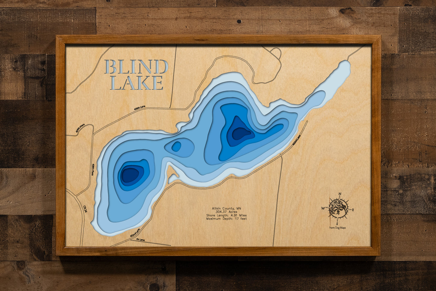 A custom-engraved, laser-cut wooden lake map of Blind Lake in Aitkin County, Minnesota. The map highlights the lake's accurate shape and complex, shallow basin, with a maximum depth of 17 feet and an extensive 4.91-mile shoreline. The design includes elegantly etched details of the lake's unique shape and surrounding features, providing a detailed, informative guide to this naturally productive lake.