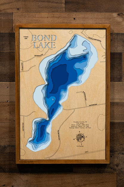 A meticulously detailed, laser-cut, multi-layered wooden map of Bond Lake in Douglas County, Wisconsin, showcasing the 279-acre trophy pike fishery with 3.84 miles of natural shoreline near Minong. The topographic design features natural wood layers highlighting the surrounding pine forests and graduated blue water layers illustrating the exceptional clarity and depths to the impressive 67-foot maximum.