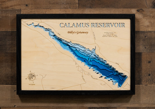 A laser-cut, layered wooden map of Calamus Reservoir in Garfield County, Nebraska. The distinct shape of this large reservoir, with its 31-mile shoreline, is clearly visible within the unique Sandhills landscape of central Nebraska. The varying depths of the lake, reaching a maximum of 44 feet, are represented by different layers of wood, illustrating its impressive underwater topography.