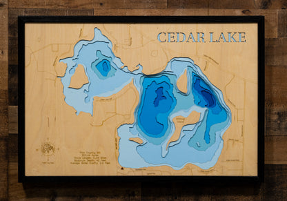A precision laser-cut, multi-layered wooden map of Cedar Lake in Rice County, Minnesota. The natural wood top layer captures over 11 miles of shoreline and four distinctive islands in fine detail, while a light-to-dark blue gradient conveys the lake's 42-foot depth. A handcrafted statement piece for any southern Minnesota lake home, cabin, or fishing enthusiast's wall.