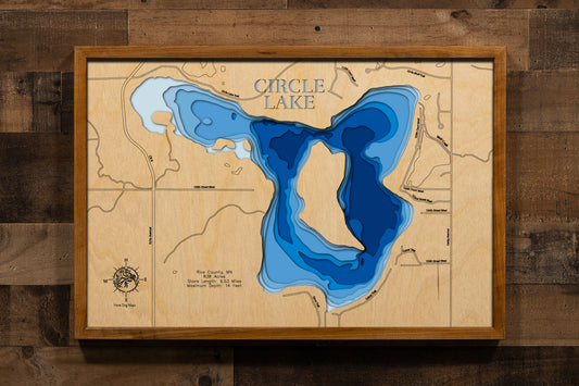 A precision laser-cut, multi-layered wooden map of Circle Lake 
in Rice County, Minnesota. This topographic art piece features 
a natural wood top layer meticulously tracing the 9.5-mile 
shoreline and the lake's distinctive islands. The recessed 
water layers are stained in a light-to-dark blue gradient, 
reflecting its 14-foot depth. It is a striking decor item, 
ideal for any cabin or modern interior, celebrating the 
natural beauty of Rice County's lake country.