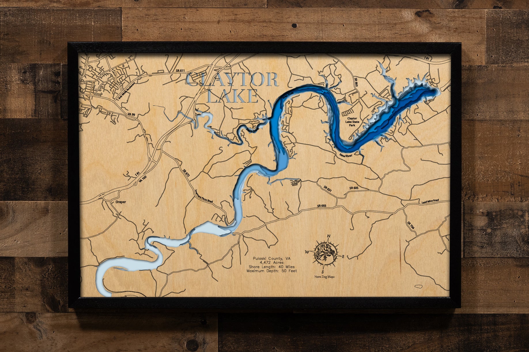 A magnificently detailed, laser-cut, multi-layered wooden topographical map of Claytor Lake in Pulaski County, Virginia, showcasing the impressive 4,472-acre reservoir stretching 21 miles along the ancient New River with over 40 miles of shoreline including dramatic shale cliffs. The natural wood top layer frames the Claytor Dam, New River Trail's Hiwassee Bridge, and Claytor Lake State Park, while graduated blue layers create a stunning visual gradient from shallower areas to the 80-foot maximum depth.