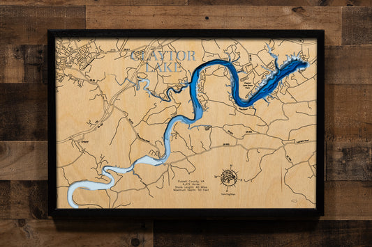 A magnificently detailed, laser-cut, multi-layered wooden topographical map of Claytor Lake in Pulaski County, Virginia, showcasing the impressive 4,472-acre reservoir stretching 21 miles along the ancient New River with over 40 miles of shoreline including dramatic shale cliffs. The natural wood top layer frames the Claytor Dam, New River Trail's Hiwassee Bridge, and Claytor Lake State Park, while graduated blue layers create a stunning visual gradient from shallower areas to the 80-foot maximum depth.