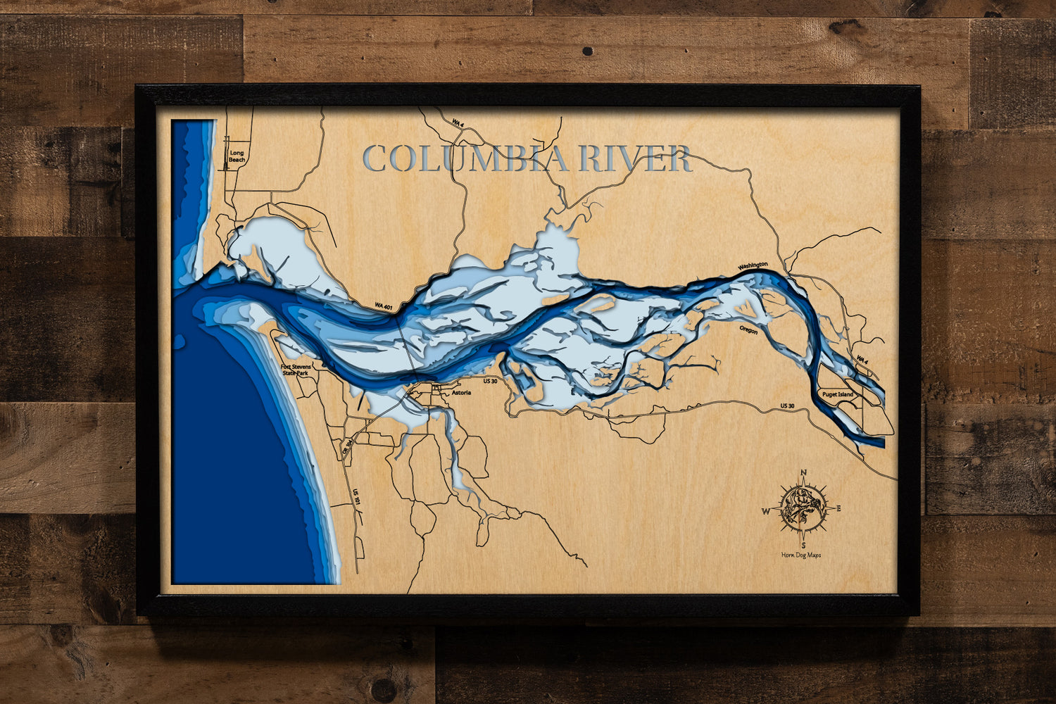 A laser-cut wooden map of the Columbia River, following its winding path along the Washington and Oregon border. The design highlights the expansive 258,000-acre waterway and its numerous dams and reservoirs. Detailed engravings showcase the dramatic topography of the Columbia River Gorge and the 1,620-mile shoreline, featuring key cities like Portland and Vancouver in a 3D topographic style.