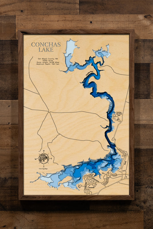 A laser-cut, layered wooden map of Conchas Lake in San Miguel County, New Mexico. The distinct shape of this large reservoir, with its 54.68-mile shoreline, is clearly visible as it winds through the northeastern New Mexico landscape. The varying depths of the lake, reaching a maximum of 158 feet, are represented by different layers of wood, illustrating its impressive underwater topography.