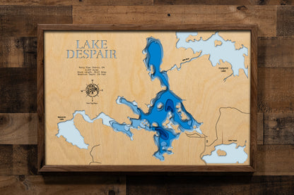 A beautifully detailed, laser-cut, multi-layered wooden map of Lake Despair in Rainy River District, Ontario, showcasing the lake's shallow contours and tea-colored waters, the intricate shoreline dotted with islands, and the connecting waterways of Mile River leading to Footprint Lake and Jackfish Narrows.