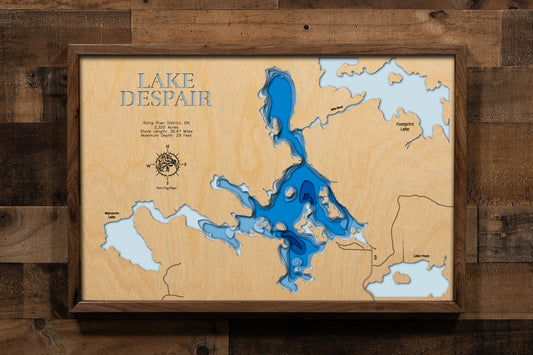 A beautifully detailed, laser-cut, multi-layered wooden map of Lake Despair in Rainy River District, Ontario, showcasing the lake's shallow contours and tea-colored waters, the intricate shoreline dotted with islands, and the connecting waterways of Mile River leading to Footprint Lake and Jackfish Narrows.