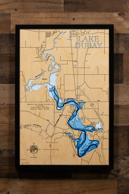 A precision laser-cut, multi-layered wooden map of Lake DuBay in Marathon and Portage Counties, Wisconsin, a 6,700-acre Wisconsin River hydroelectric reservoir between Wausau and Stevens Point with 42.3 miles of shoreline. The natural wood top layer captures every curve of this sprawling reservoir in fine detail, while a light-to-dark blue gradient conveys its 30-foot depth. A handcrafted statement piece for any Wisconsin lake home, cabin, or outdoor enthusiast's wall.