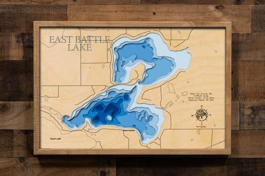 A meticulously crafted laser-cut wooden lake map of East Battle Lake in Otter Tail County, Minnesota. The map features the lake's accurate shape and detailed shoreline, with its impressive depth represented by a deep blue stain. Meticulously etched details include the lake's unique shape, its shore length, and maximum depth, providing both a beautiful piece of art and a detailed, informative guide to this popular Minnesota lake.