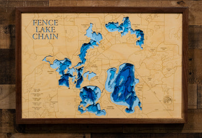 A laser-cut, layered wooden map of the Fence Chain of Lakes in Vilas County, Wisconsin. The interconnected shapes of Fence Lake, Crawling Stone Lake, Flambeau Lake, Pokegama Lake, and White Sand Lake are clearly visible within the Vilas County landscape. The varying depths of each lake are represented by different layers of wood, illustrating the underwater topography of this beautiful chain.