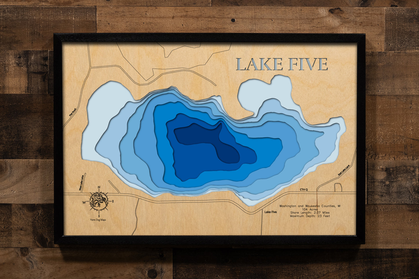 A precision laser-cut, multi-layered wooden map of Lake Five in 
Richfield, Wisconsin. The natural wood top layer captures every 
detail of the 2.07-mile shoreline, while the recessed water layers 
feature a vibrant light-to-dark blue gradient to show the 23-foot 
depth. This elegant 3D topographic art piece is a sophisticated 
home decor item, perfect for cabin walls or modern interiors 
looking for a rustic, handcrafted touch.