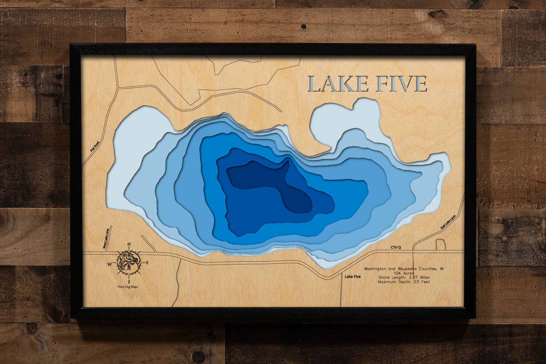 A precision laser-cut, multi-layered wooden map of Lake Five in 
Richfield, Wisconsin. The natural wood top layer captures every 
detail of the 2.07-mile shoreline, while the recessed water layers 
feature a vibrant light-to-dark blue gradient to show the 23-foot 
depth. This elegant 3D topographic art piece is a sophisticated 
home decor item, perfect for cabin walls or modern interiors 
looking for a rustic, handcrafted touch.