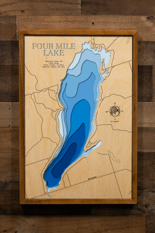 A precision laser-cut wooden map of Four Mile Lake in Ontario, 
Canada, featuring a natural wood top layer and a multi-level blue 
gradient for the water. The 3D topographic design highlights the 
15-mile shoreline and 65-foot depth in a sophisticated art piece. 
It is a rustic yet modern home decor item that perfectly captures 
the unique contours of this Kawartha Lakes reservoir for any wall.