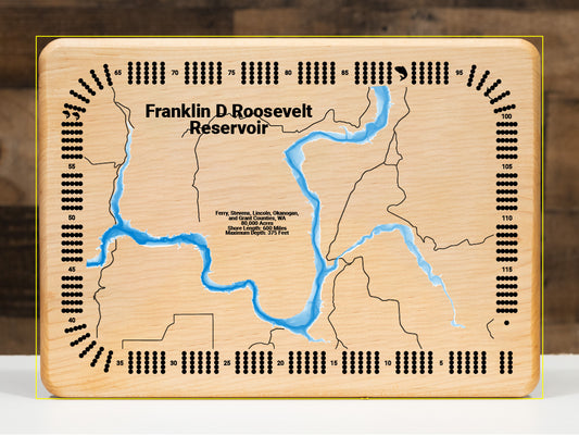 A precision laser-cut, multi-layered wooden map of Franklin D. Roosevelt Lake spanning five counties in northeastern Washington State. The natural wood top layer captures 600 miles of dramatic Columbia River reservoir shoreline in extraordinary detail, while a light-to-dark blue gradient highlights the water's depth of 375 feet. A breathtaking, rustic statement piece for any Pacific Northwest cabin, lake home, or outdoor enthusiast's space.