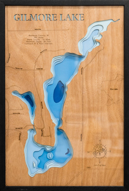 Laser-engraved relief map of Gilmore Lake in Washburn County, WI, crafted from wood with high precision.