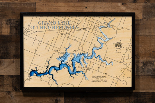 A laser-cut, layered wooden map of Grand Lake O' the Cherokees in Craig, Delaware, Mayes, and Ottawa Counties, Oklahoma. The expansive and serpentine shape of this major reservoir, stretching through the northeastern Oklahoma landscape, is clearly visible. The varying depths of the lake, reaching a maximum of 133 feet, are represented by different layers of wood, illustrating its significant underwater topography.