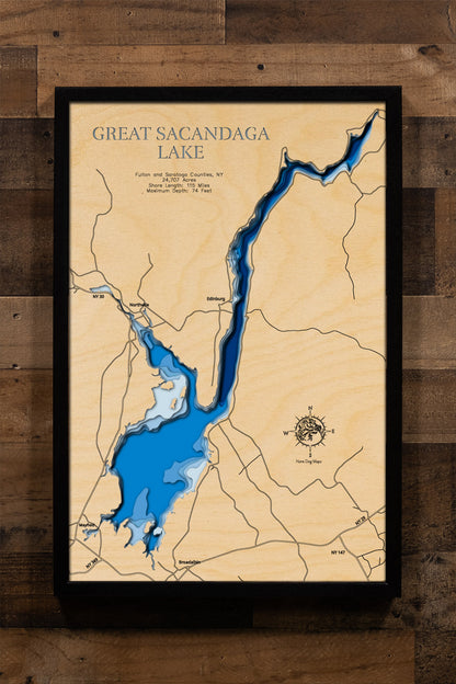 A laser-cut, layered wooden map of Great Sacandaga Lake in New York. The expansive and irregular shape of this large reservoir is clearly visible as it stretches through Fulton and Saratoga Counties. The varying depths of the lake, reaching a maximum of 74 feet, are represented by different layers of wood, illustrating its underwater topography.