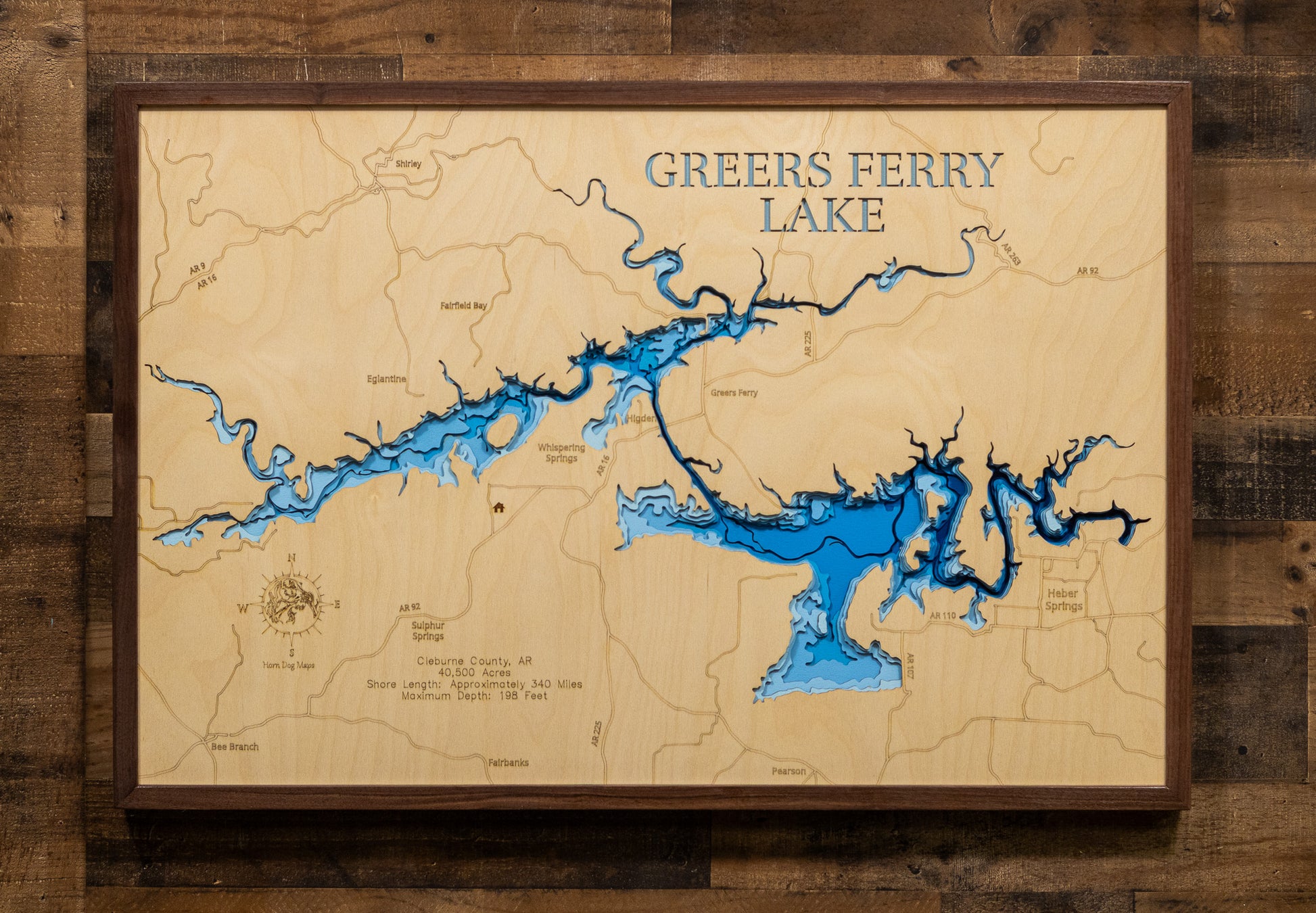 A laser-cut, layered wood map of Greers Ferry Lake, Arkansas, showcasing its winding shoreline and surrounding mountain features.