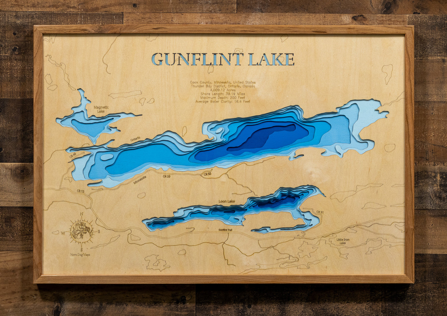 Laser-engraved relief map of Gunflint Lake in Cook County, MN, Thunder Bay District, ON, crafted from wood with high precision.