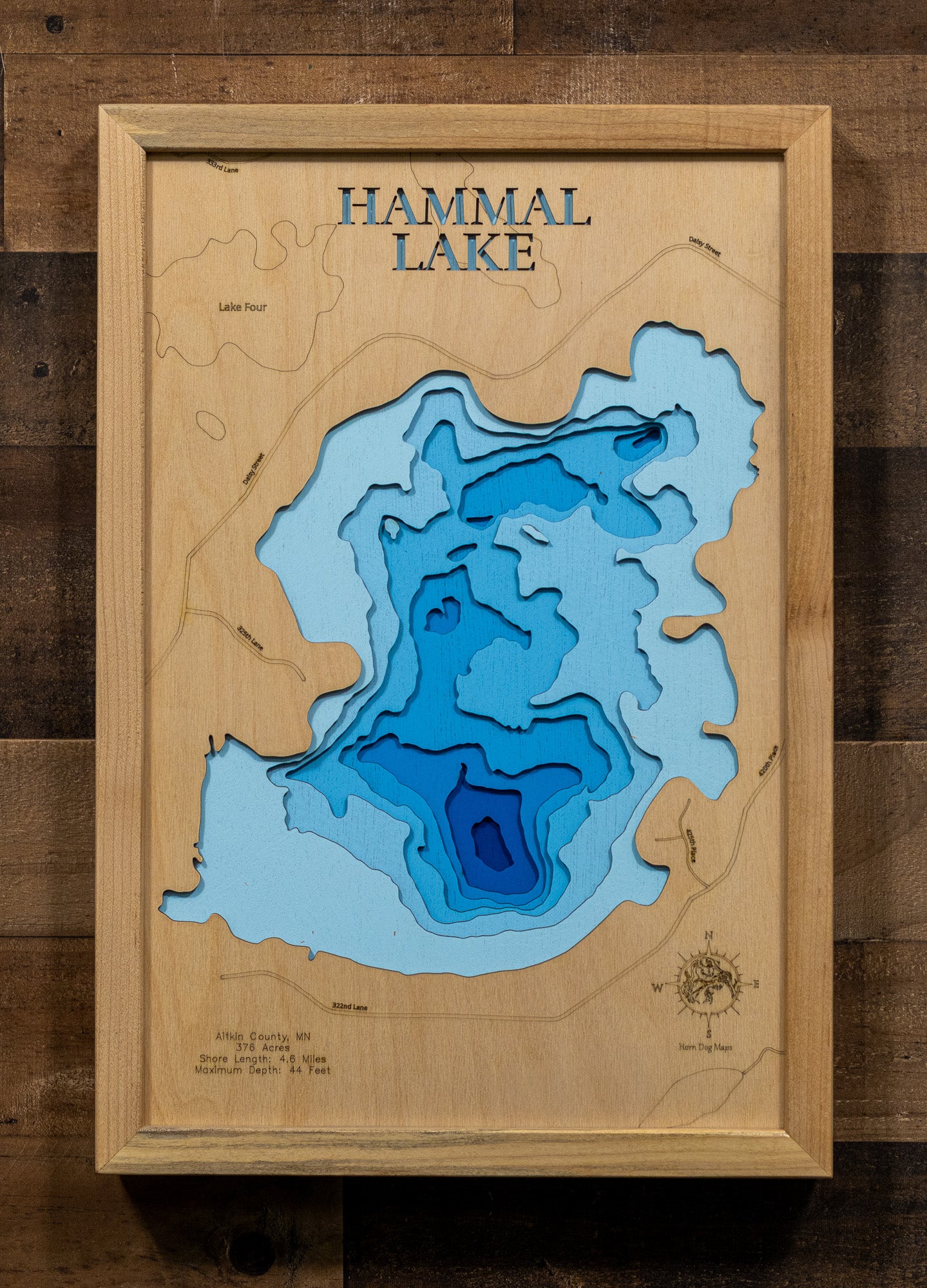 A precision laser-cut, multi-layered wooden map of Hammal Lake in 
Aitkin County, Minnesota. The natural wood top layer captures the 
intricate 4.6-mile shoreline, while the recessed water layers are 
stained with a light-to-dark blue gradient to represent the 44-foot 
depth. This elegant 3D topographic art piece serves as a 
sophisticated focal point for any cabin wall or modern home interior, 
showcasing the lake's unique geometry.