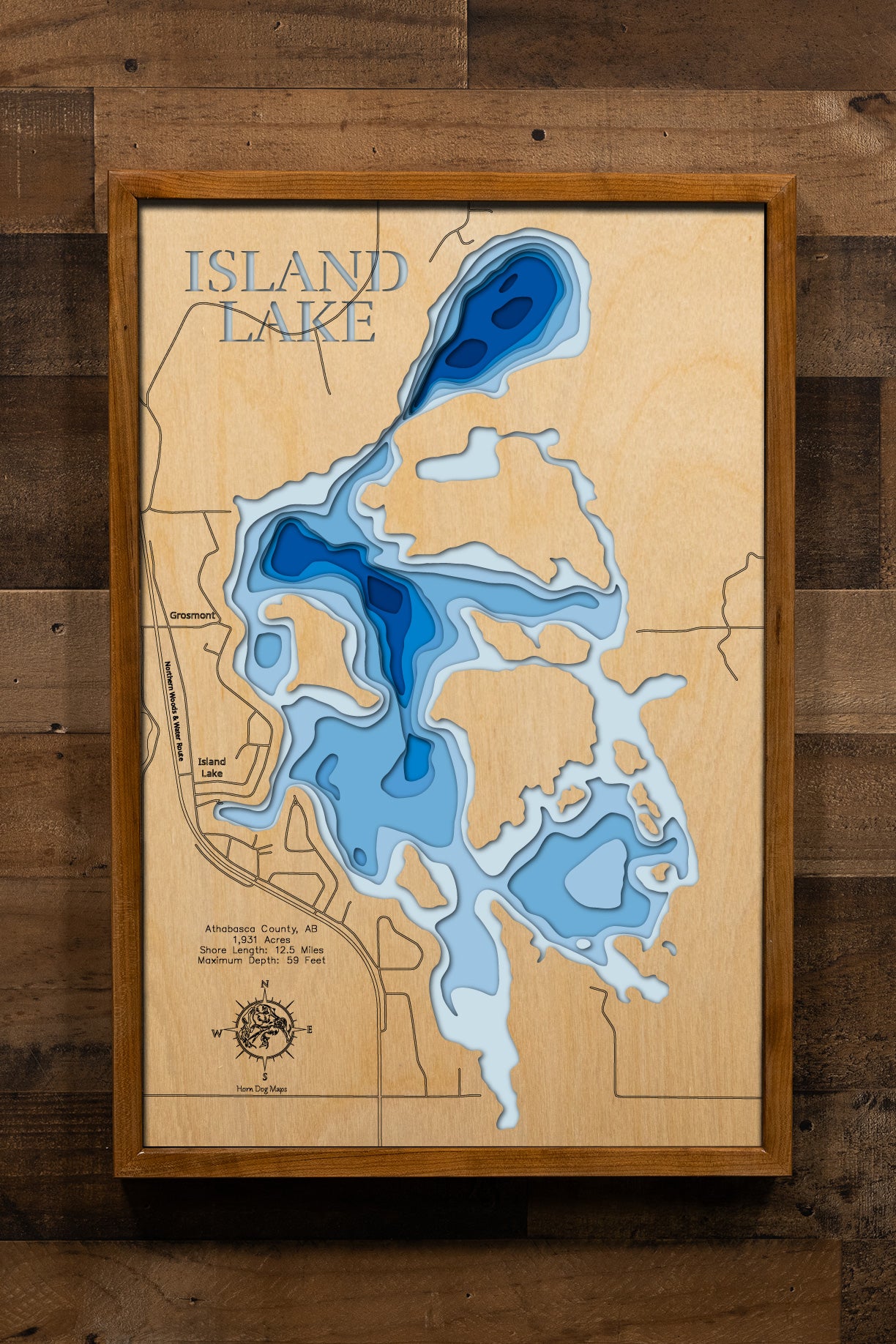 A highly detailed, laser-cut, and multi-layered wooden map of Island Lake in Athabasca County, Alberta. The map showcases the lake's 1,931-acre surface featuring multiple distinctive islands and bays, depth contours illustrating the shallow main basin contrasting with the deep 59-foot northern basin, the narrow connecting channel, and 12.5 miles of boreal forest shoreline.