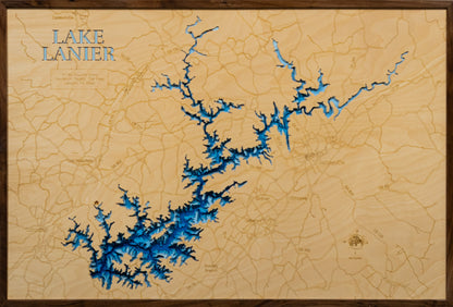 A laser-cut, layered wooden map of Lake Lanier, located in Dawson, Forsyth, Gwinnett, Hall, and Lumpkin Counties, Georgia. The expansive and intricate shape of the reservoir, with its many arms and coves, is clearly visible within the northern Georgia landscape. The varying depths of the lake, reaching a maximum of 156 feet, are represented by different layers of wood, illustrating its underwater topography.